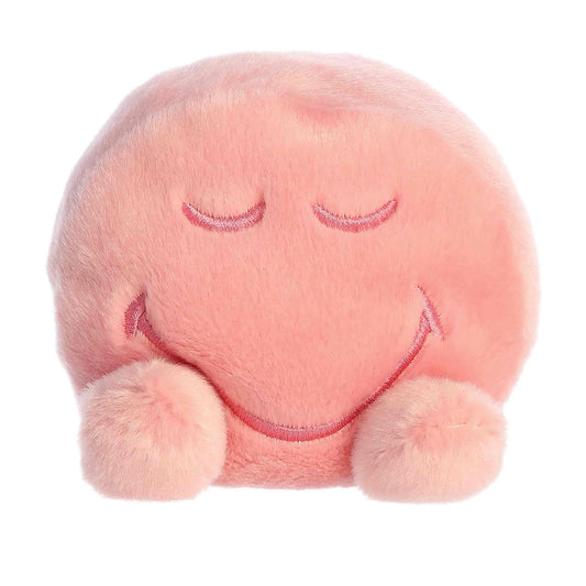 Straight front view of the sitting pink smiley face plush showing its peaceful closed-eye embroidered expression and little plush feet.