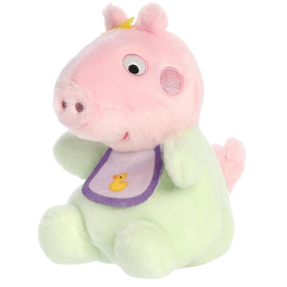 Angled side view of the cute pink plush pig sitting down in her green onesie.
