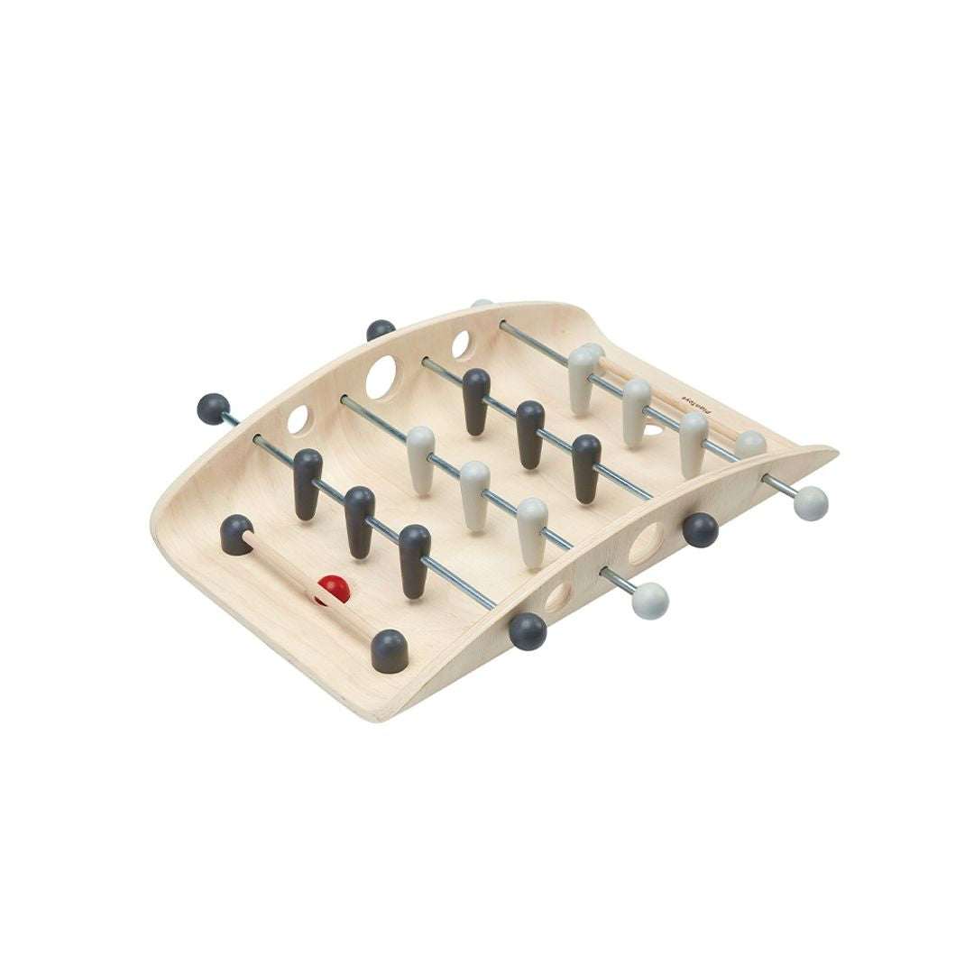 Side profile of the chemical-free rubberwood PlanToys tabletop soccer board showing the smooth player rods.