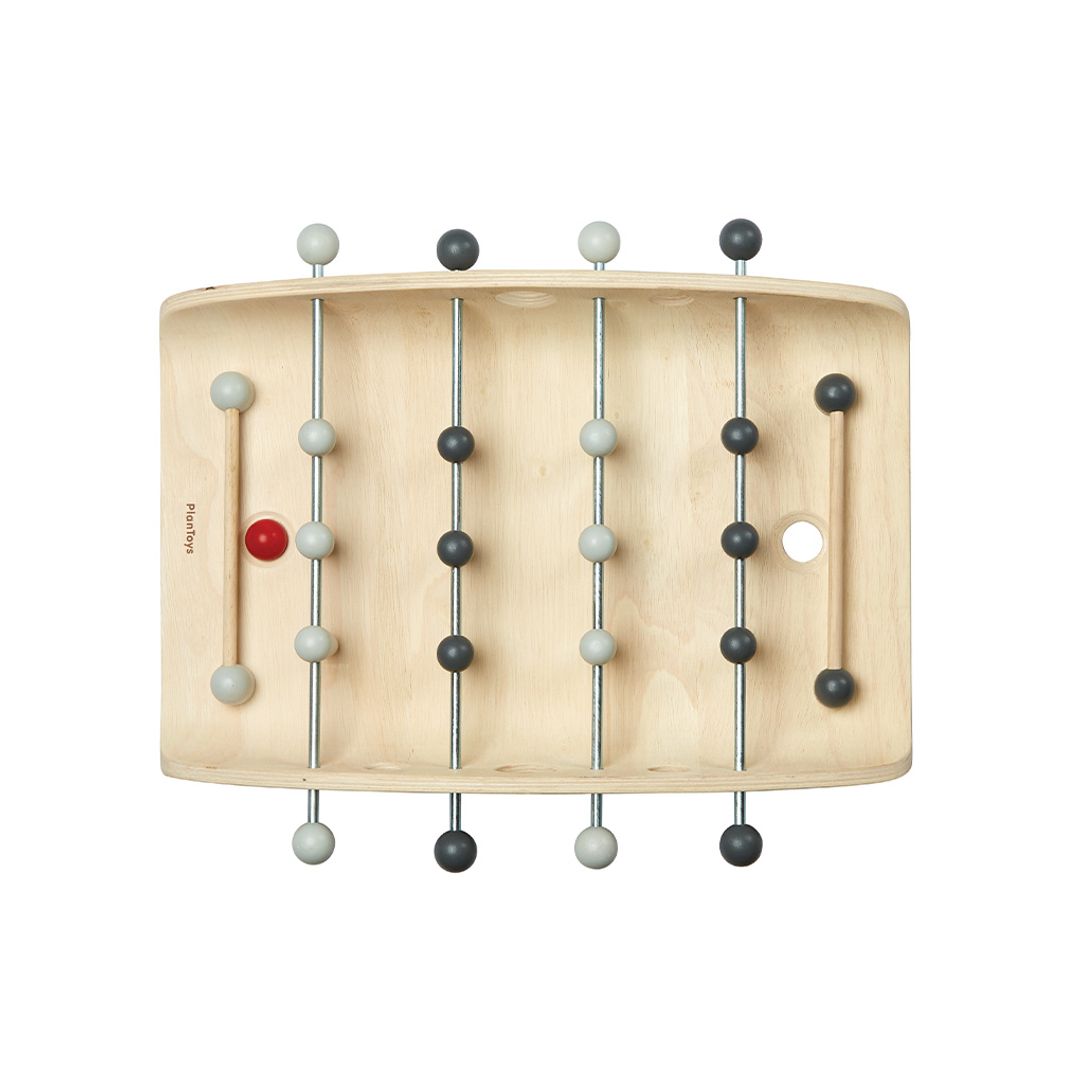 Top-down view of the PlanToys eco-friendly foosball table highlighting the light and dark grey wooden players.