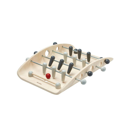 Front angle of the eco-friendly PlanToys wooden tabletop soccer game with a curved board and red ball.