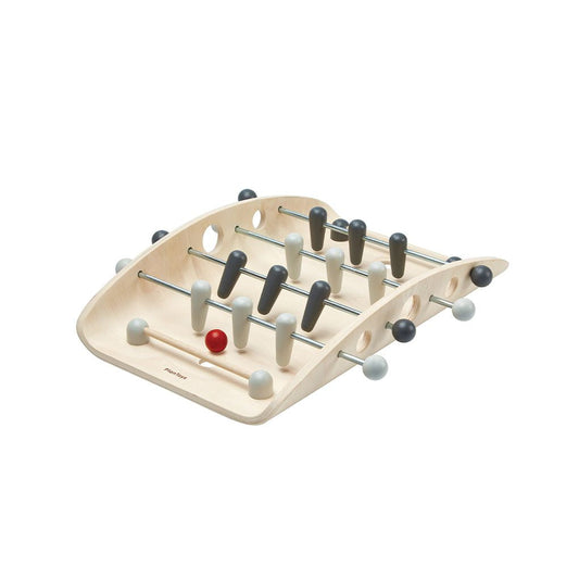 Front angle of the eco-friendly PlanToys wooden tabletop soccer game with a curved board and red ball.