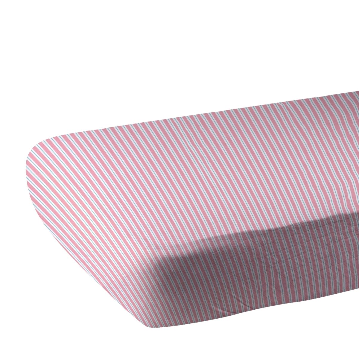 Close-up of the pink and white pinstripe bamboo muslin fabric showing the fitted corner of the crib sheet.