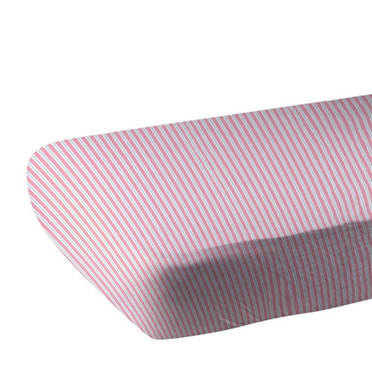 Close-up of the pink and white pinstripe bamboo muslin fabric showing the fitted corner of the crib sheet.