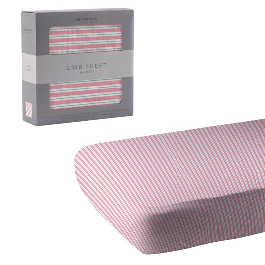 Newcastle Classics Candy Stripe pink and white bamboo crib sheet unrolled next to its grey retail window box.