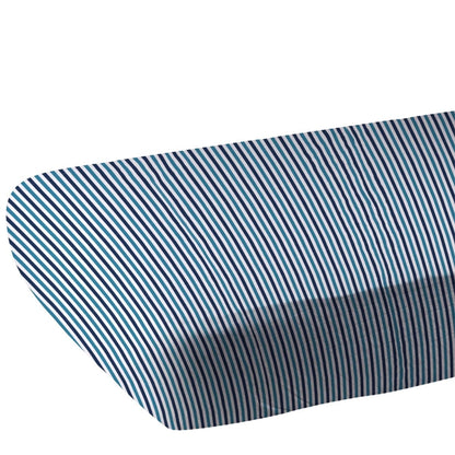 Close-up of the blue and white pinstripe bamboo muslin fabric showing the fitted corner of the crib sheet.
