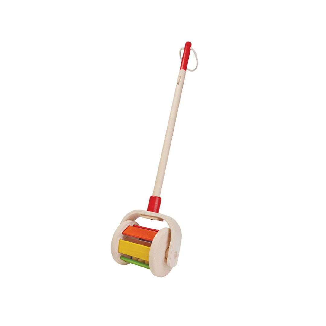 Isolated view of the chemical-free PlanToys toddler push toy ready for active, screen-free walking play.