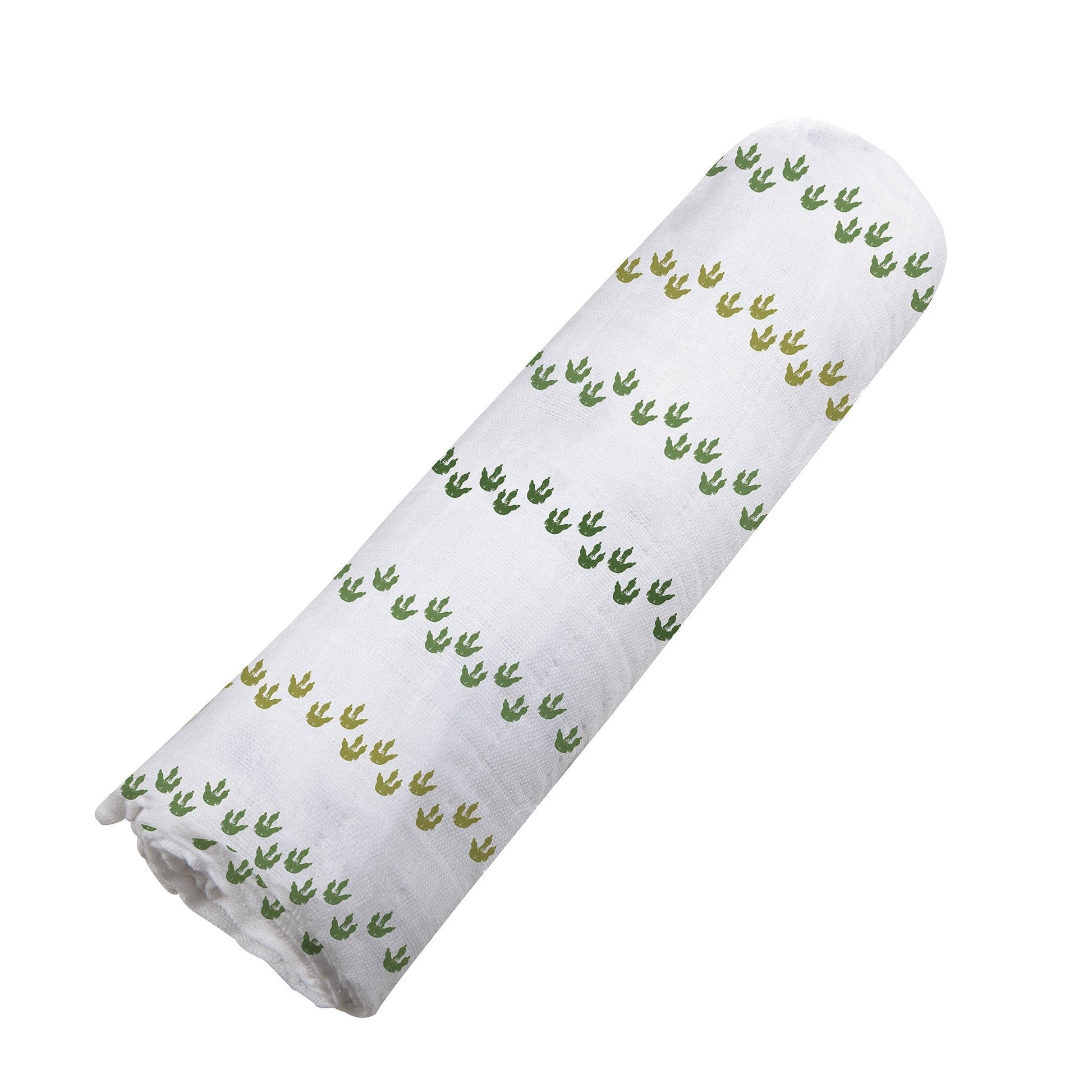Angled view of the white and green Dino Feet print cotton muslin swaddle blanket neatly rolled up.
