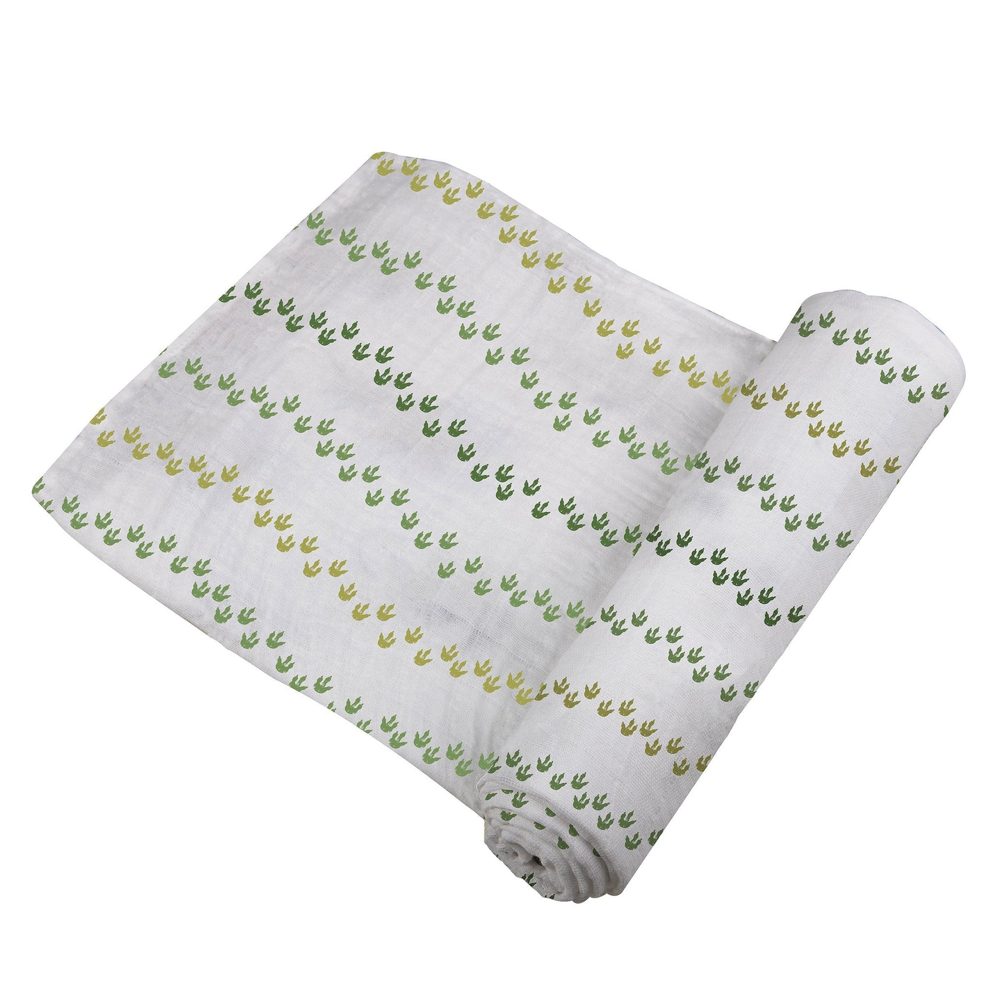 Angled view of the swaddle blanket partially unrolled to showcase the wavy lines of green dinosaur footprints.