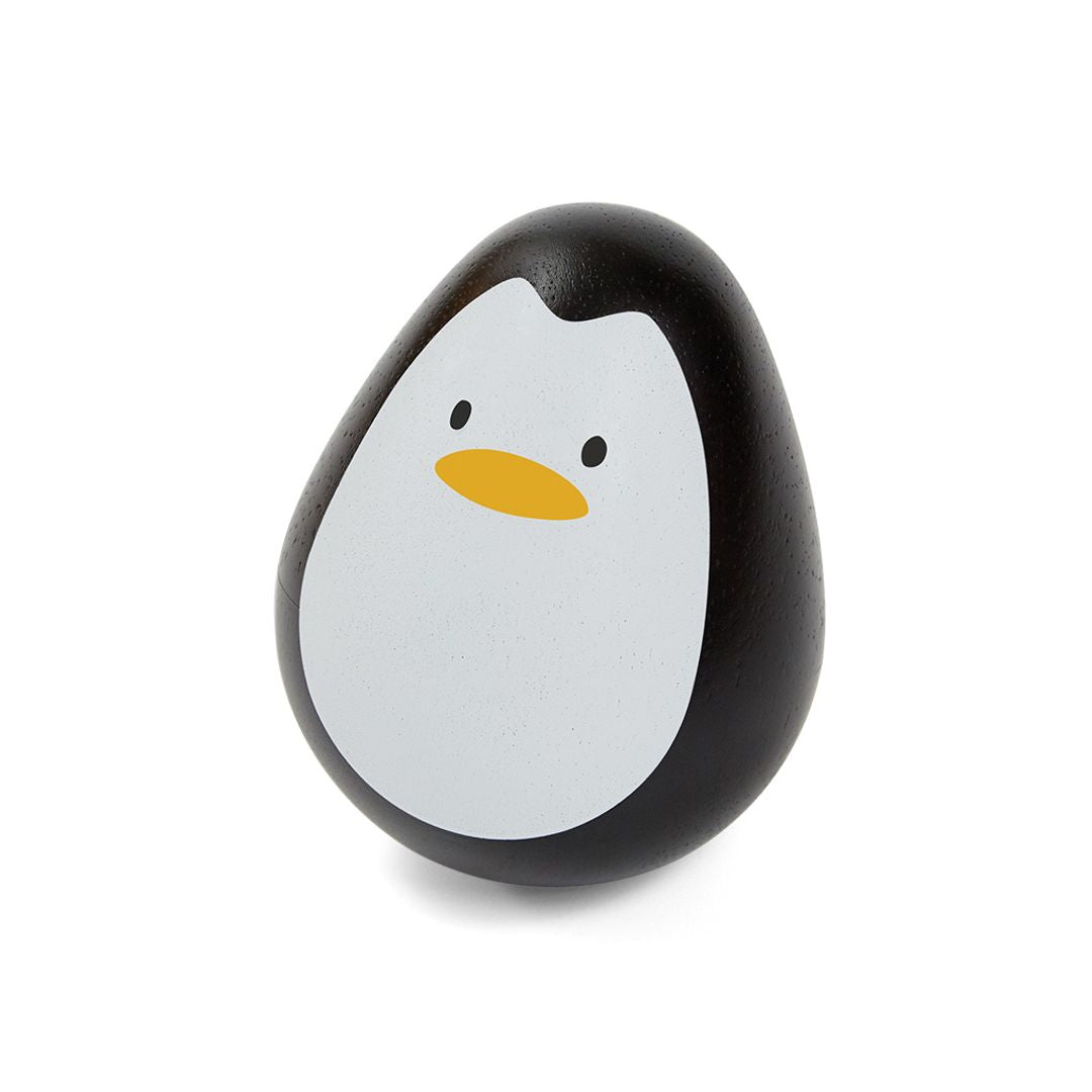Front profile of the sustainable PlanToys wooden penguin wobbler featuring a black and white body and a yellow beak.