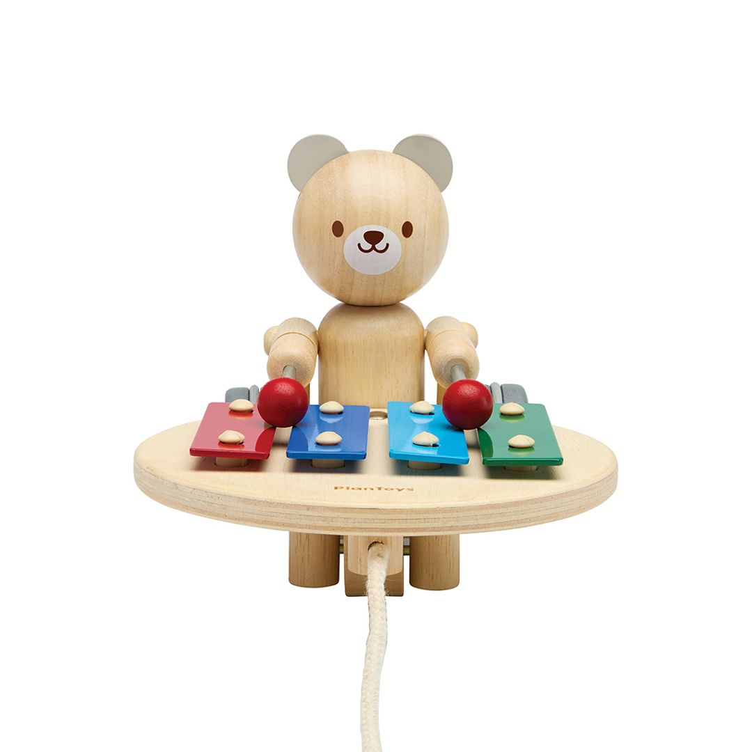 Front profile of the non-toxic PlanToys pull along bear highlighting its cute facial features and colorful musical keys.