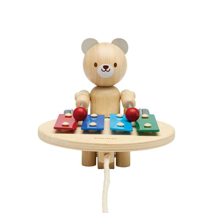 Front profile of the non-toxic PlanToys pull along bear highlighting its cute facial features and colorful musical keys.