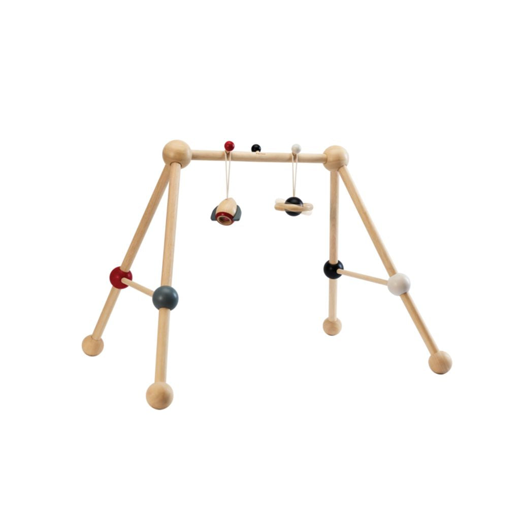 Front view of the eco-friendly PlanToys wooden baby play gym in high contrast colors featuring dangling sensory toys.