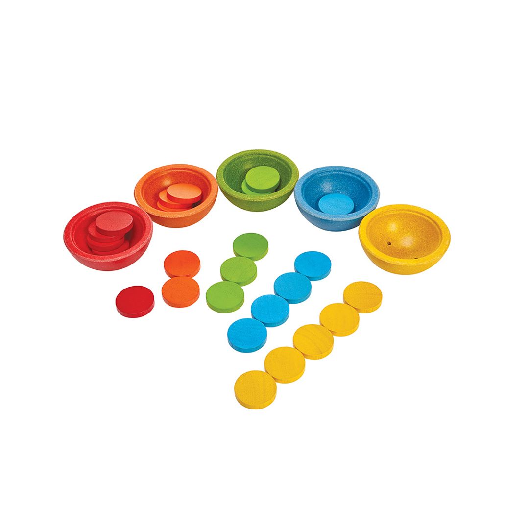 The chemical-free rubberwood PlanToys sorting set showing the red, orange, green, blue, and yellow cups with their matching coins.