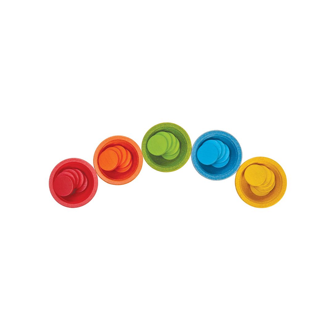Five brightly colored, earth-friendly wooden cups from the PlanToys educational sorting set lined up in a row.
