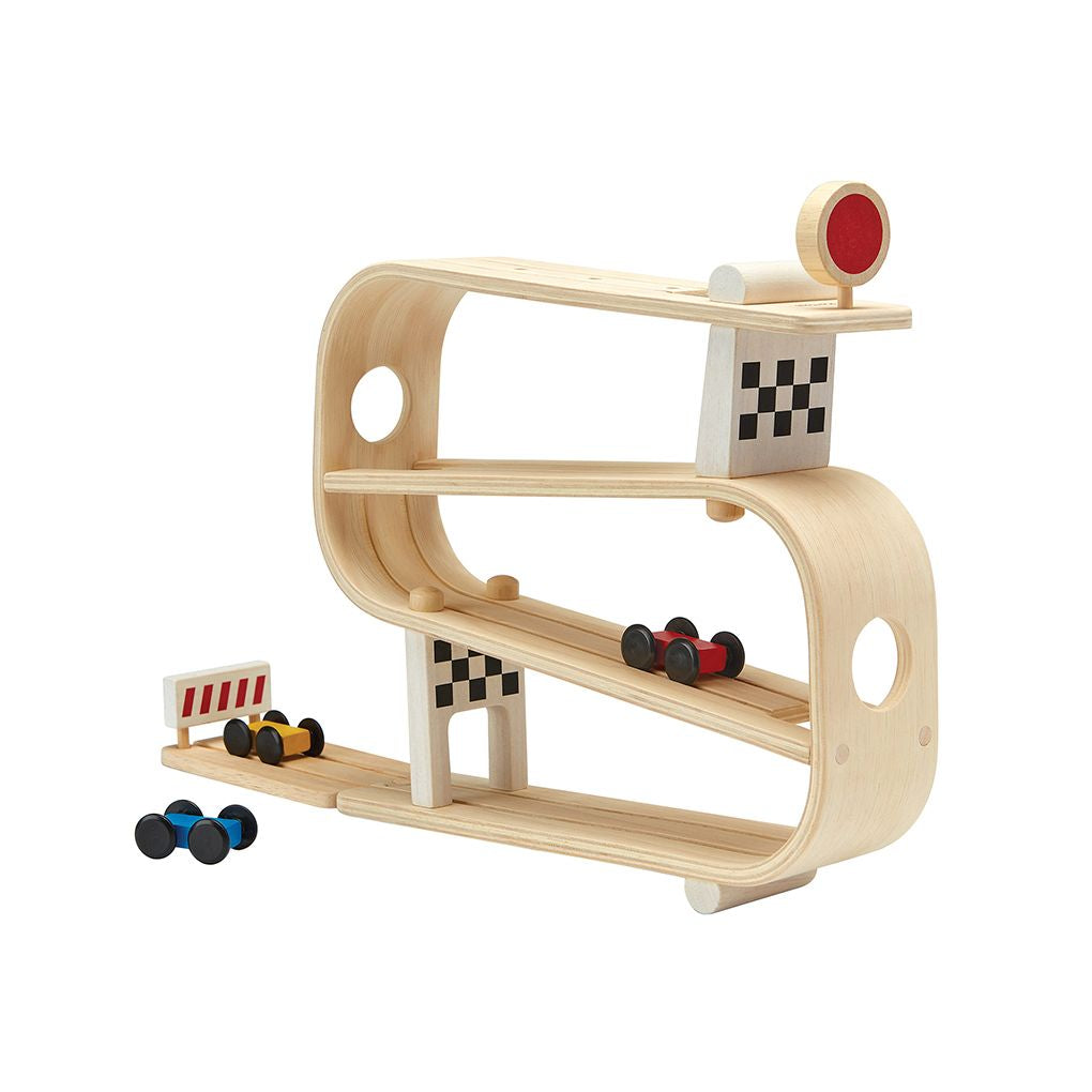Side profile of the multi-level chemical-free rubberwood PlanToys car track with three colorful racers.