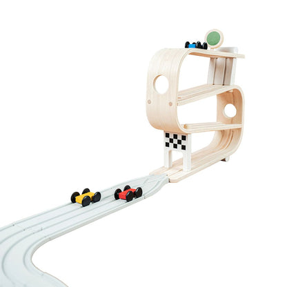 The PlanToys wooden ramp racer seamlessly connected to the interlocking PlanToys road system for expanded play.