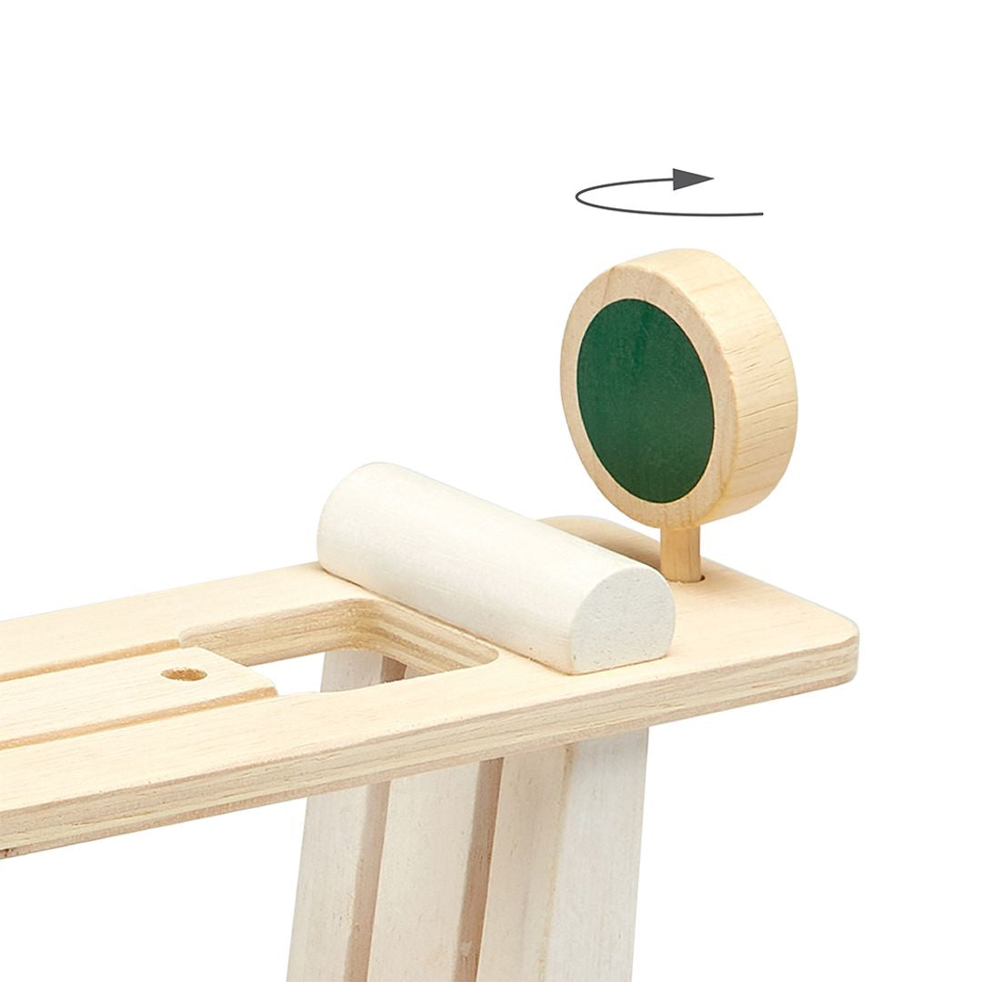 Detailed view showing the interactive spinning start and stop sign at the top of the PlanToys ramp.
