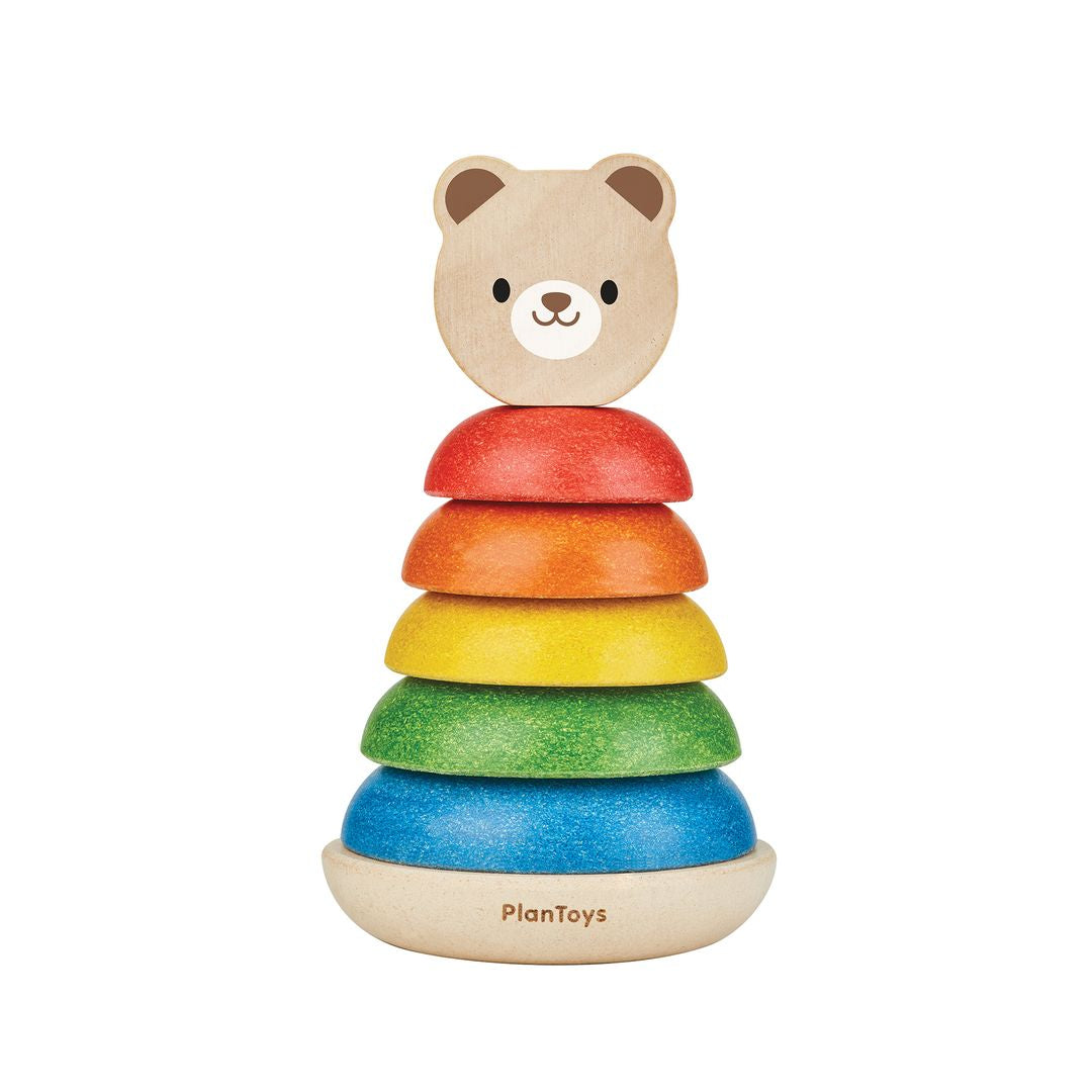 Isolated front view of the fully assembled PlanToys wooden bear stacker with its colorful rings.