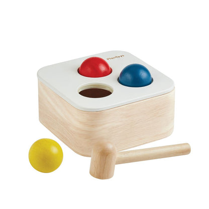 The PlanToys wooden punch and drop bin featuring a natural wood finish and colorful accents.