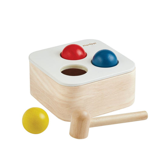 The PlanToys wooden punch and drop bin featuring a natural wood finish and colorful accents.