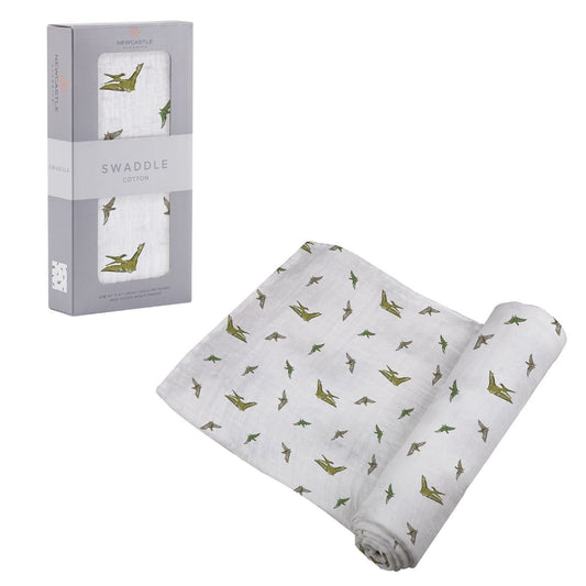 Partially unrolled Newcastle Classics Pteranodon cotton muslin swaddle blanket displayed next to its grey window packaging box.