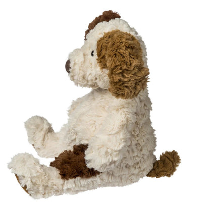 Side view of the slouchy Snuggables puppy plush showing its weighted bottom and soft spotted fabric.