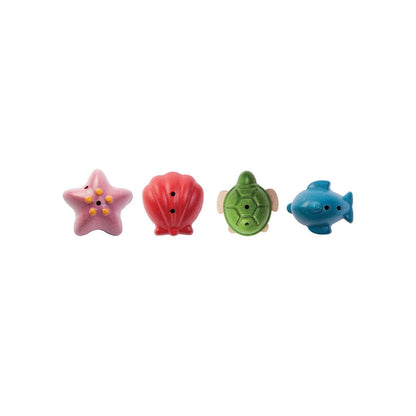 The complete PlanToys wooden sea life bath set lined up in a row showing the starfish, shell, turtle, and dolphin.