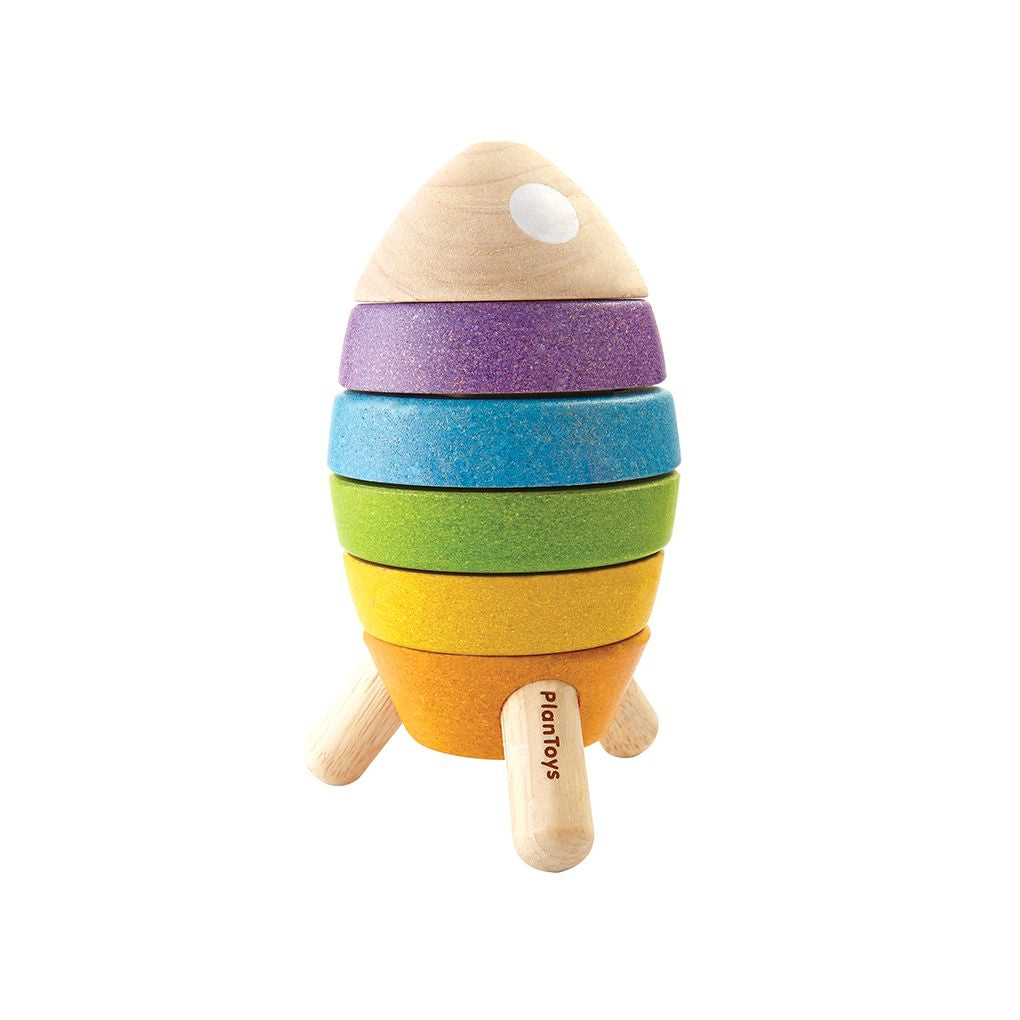 Front view of the fully assembled PlanToys wooden stacking rocket featuring orange, yellow, green, blue, and purple rings.