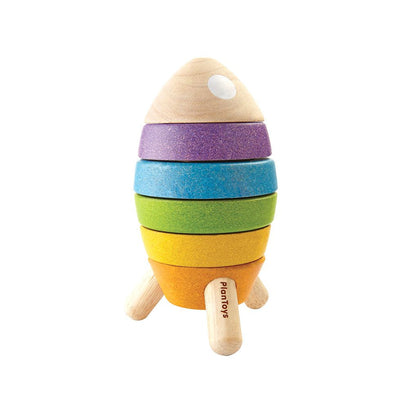 Front view of the fully assembled PlanToys wooden stacking rocket featuring orange, yellow, green, blue, and purple rings.