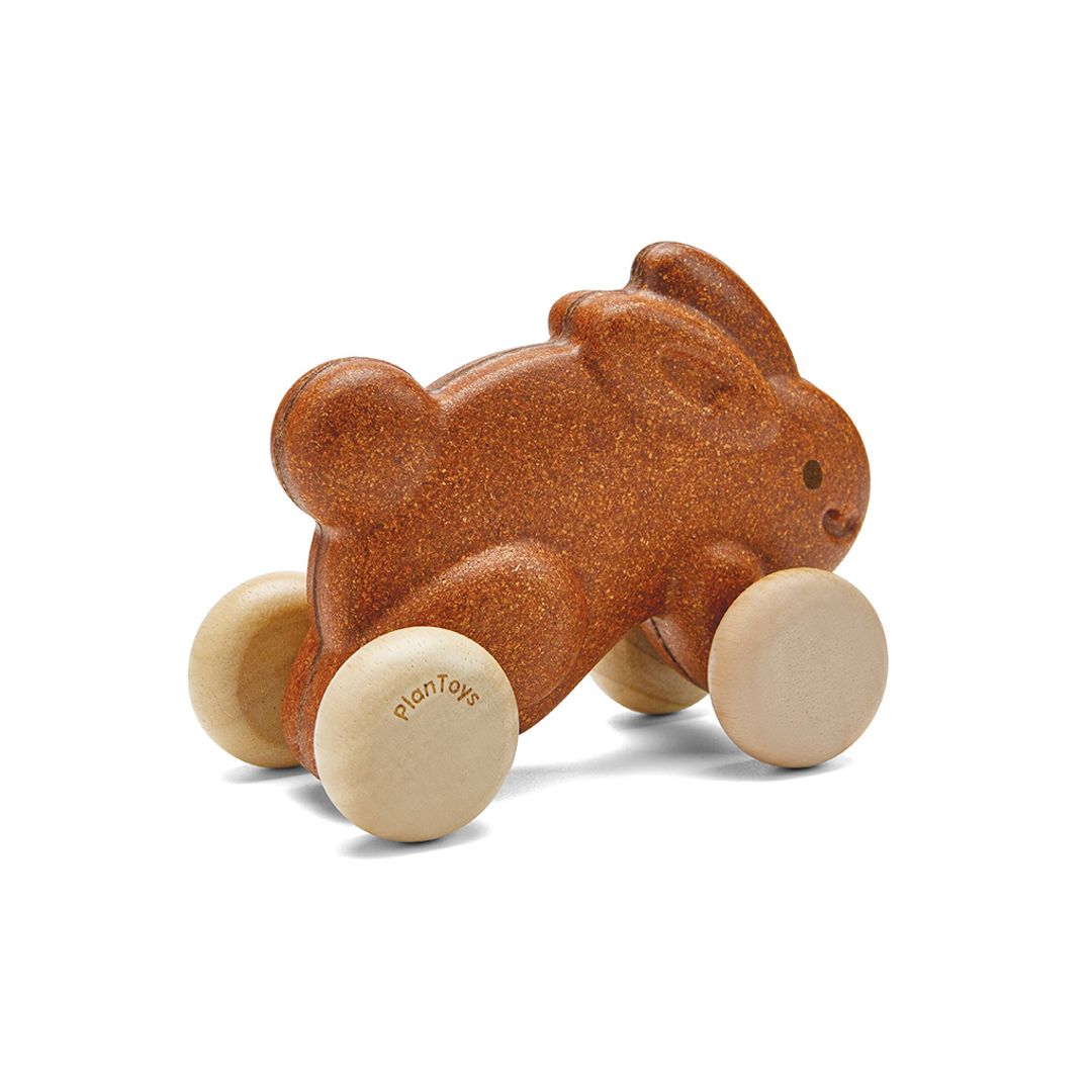 Side profile of the durable brown PlanToys push along bunny showcasing its solid rubberwood wheels and safe, rounded edges.