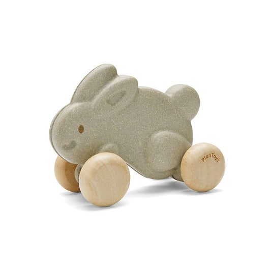The PlanToys wooden push along bunny in grey 