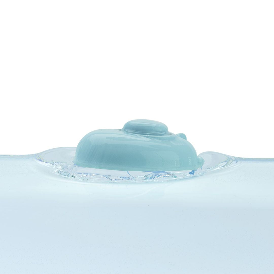 The eco-friendly PlanToys natural rubber boat converted into a submarine and floating just above the water's surface.