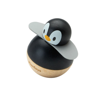 Angled left view of the smooth, earth-friendly PlanToys wooden penguin baby toy with soft wings.