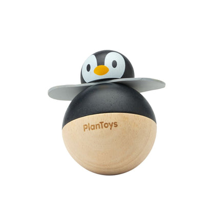 Isolated straight-on view of the modern PlanToys wooden penguin wobbler ready for nursery play.