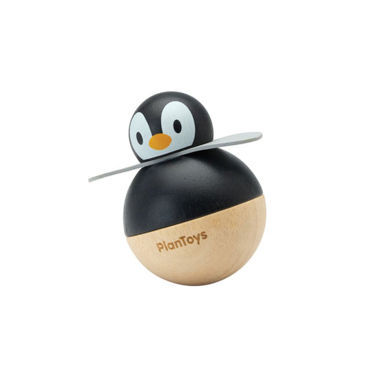 Front profile of the sustainable PlanToys wooden penguin wobbler featuring a black and natural wood body with grey wings.