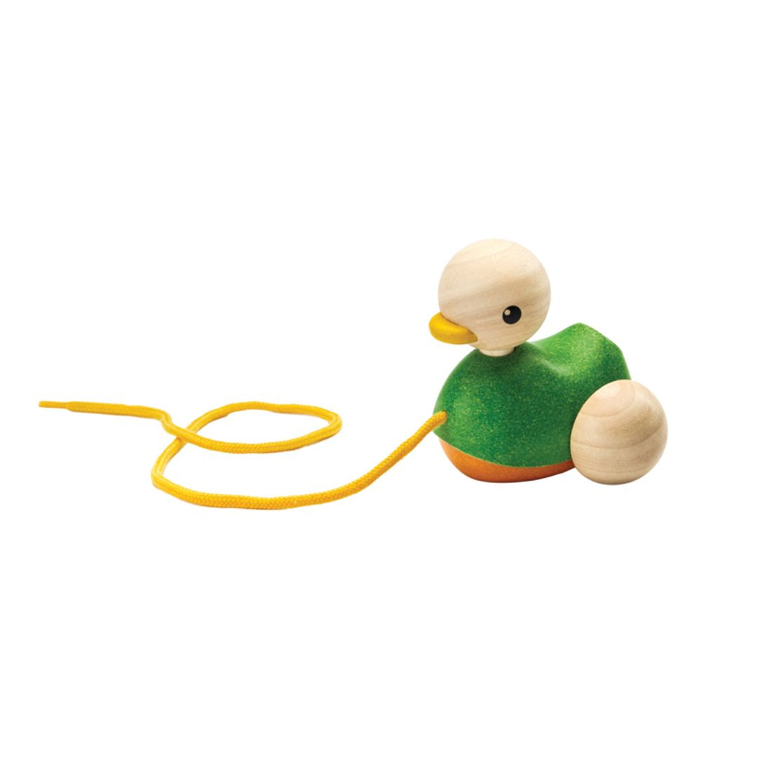 Side profile of the chemical-free rubberwood PlanToys pull along bird with its yellow string loosely coiled.