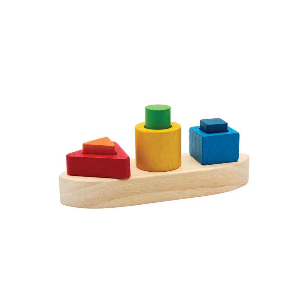 Front view of the eco-friendly PlanToys wooden shape sorting boat featuring nested red, blue, green, and yellow blocks.