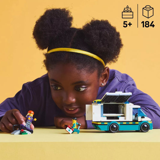 Child playing with a toy vehicle and figures on a yellow background