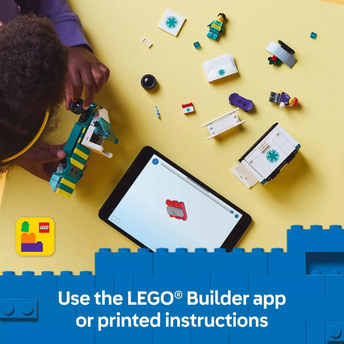 Person building with LEGO bricks on a yellow surface, using a tablet with LEGO app.
