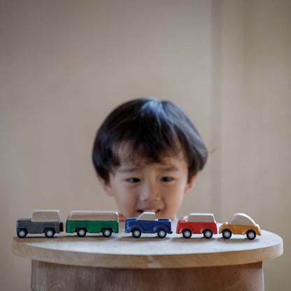 Close-up of the eco-friendly PlanToys wooden cars during imaginative city play.