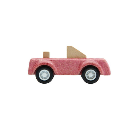 Side angle of the PlanToys wooden pink sports car toy.