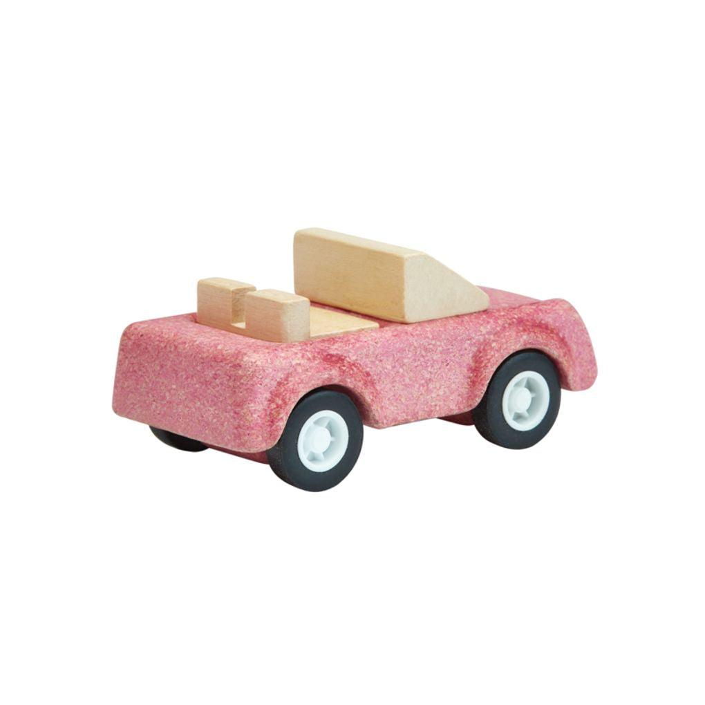 Back side of the PlanToys wooden pink sports car toy.