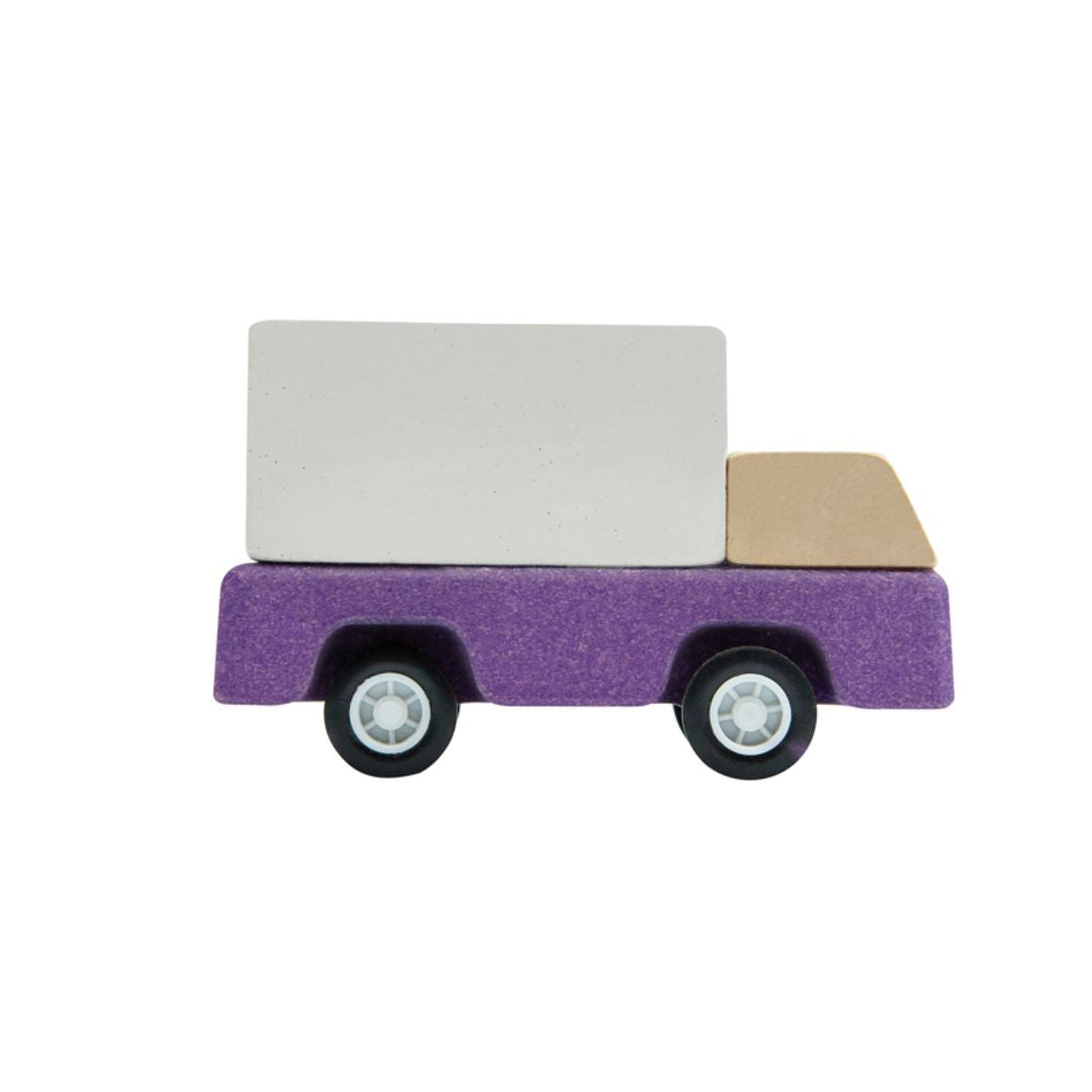 Side view showing the smooth rolling wheels on the PlanToys eco-friendly purple truck.