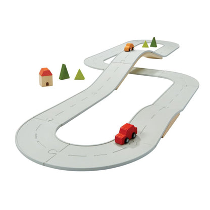 The massive PlanToys Large Rubber Road and Rail Set completely assembled with the wooden bridge, vehicles, and trees.
