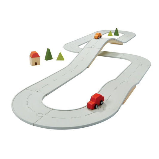 The massive PlanToys Large Rubber Road and Rail Set completely assembled with the wooden bridge, vehicles, and trees.