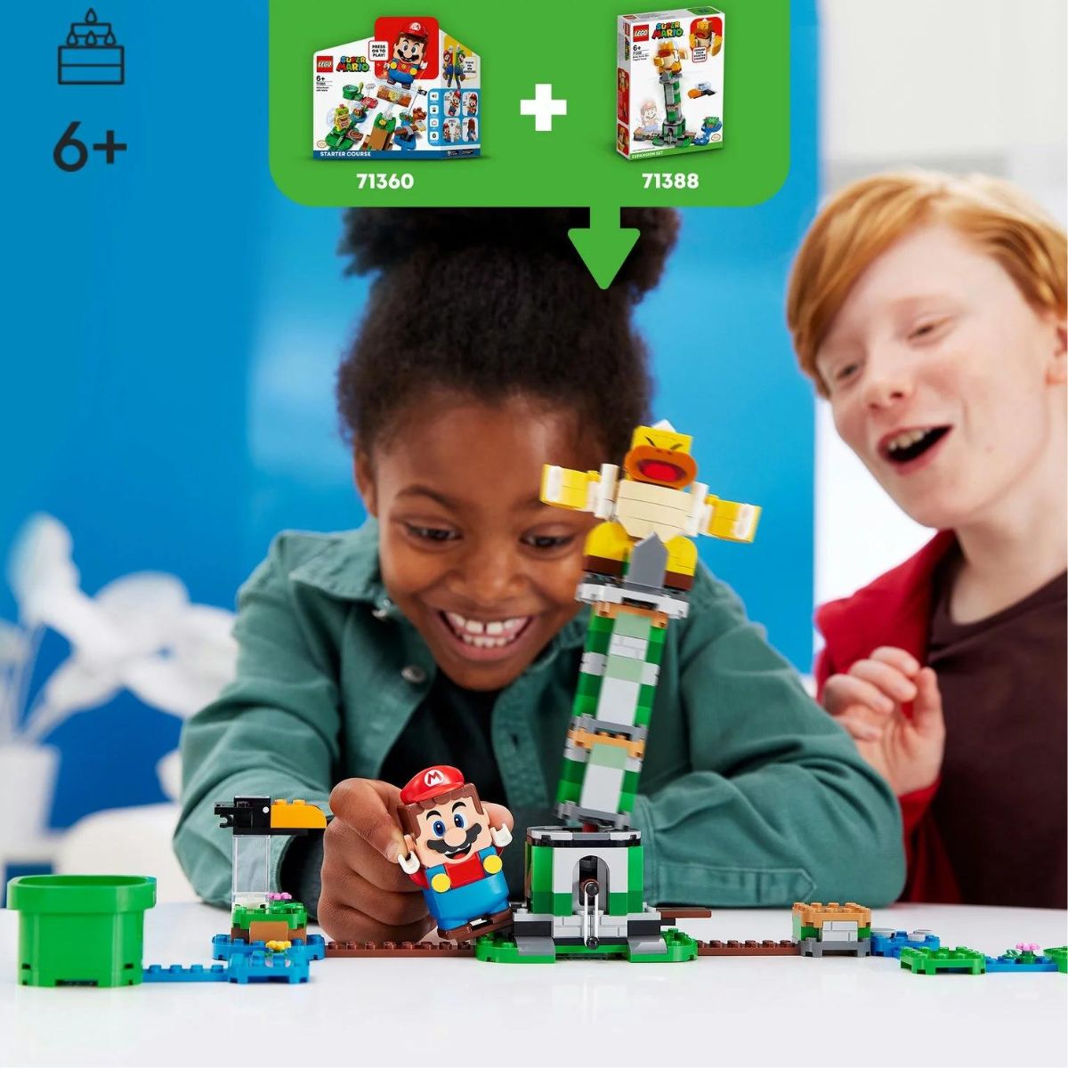 Two kids happily playing with the LEGO Super Mario Topple Tower, using a Mario figure to jump on the base levers.
