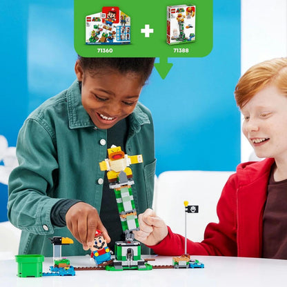 Two kids smiling as they successfully topple the Boss Sumo Bro from the top of the tower during interactive play.