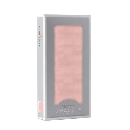Angled front view of the packaged Pink Rose baby swaddle blanket folded inside a grey Newcastle Classics display box.