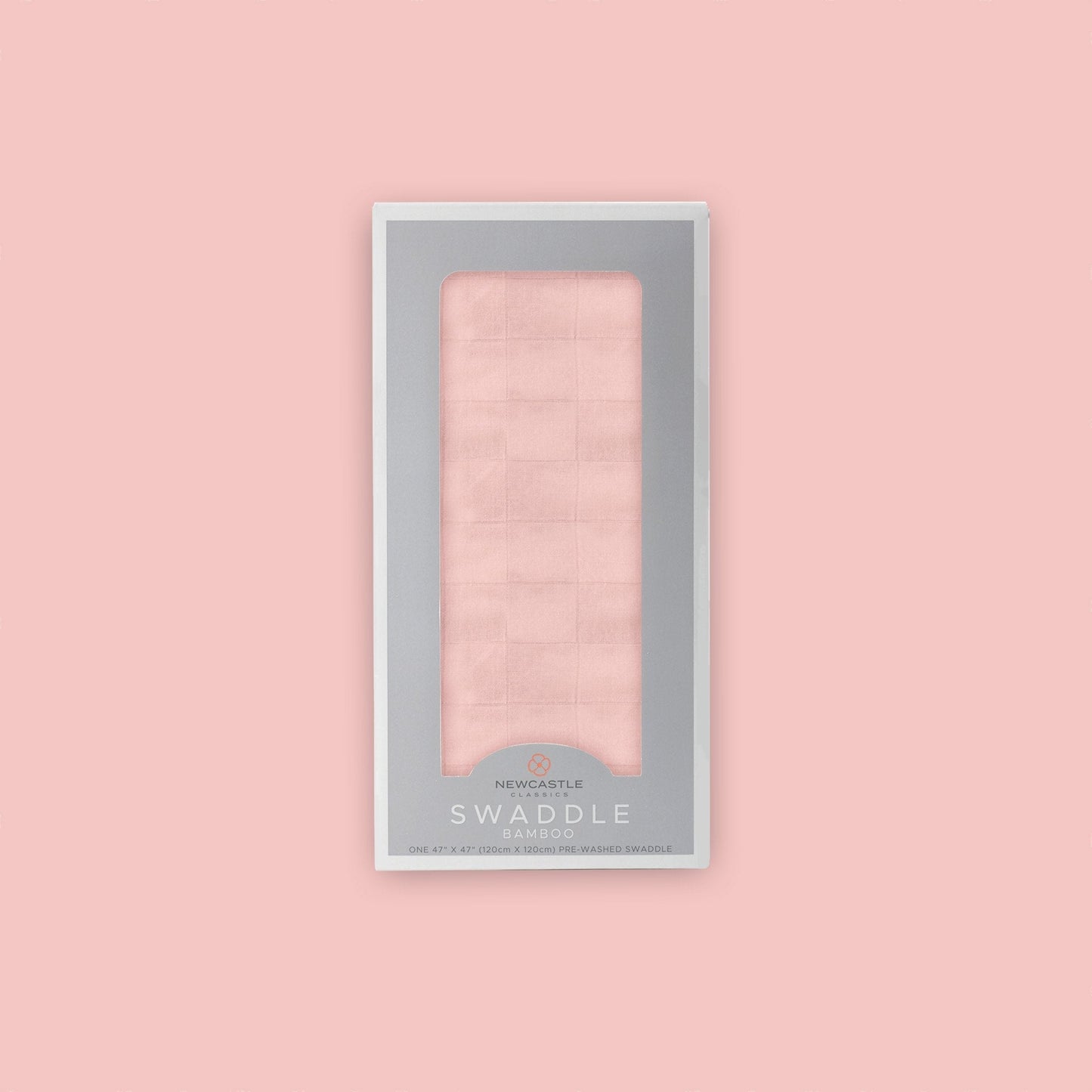 Straight front view of the packaged Newcastle Classics Pink Rose bamboo muslin swaddle blanket in a grey window box set against a matching solid pink background.